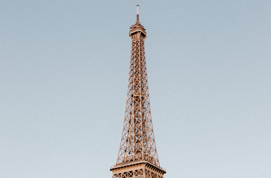 A breathtaking capture of the Eiffel Tower in Paris on a clear day, showcasing its architectural magnificence.