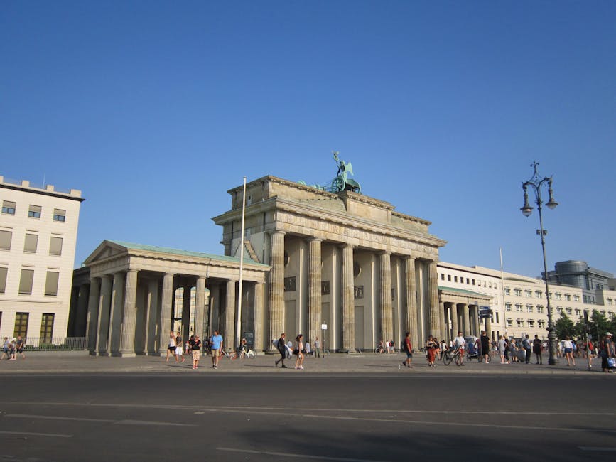 Explore the iconic Brandenburg Gate during a sunny day in Berlin, perfect for travel and tourism imagery.